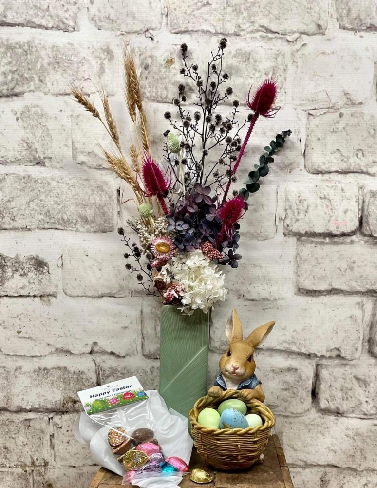 Preserved flower arrangement, ceramic bunny carrying basket, easter eggs