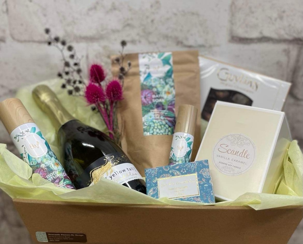 Scandle candle, sparkling wine, soap box, Organik Wellness & Co. Bath Soak, Body Moisturiser & chocolates