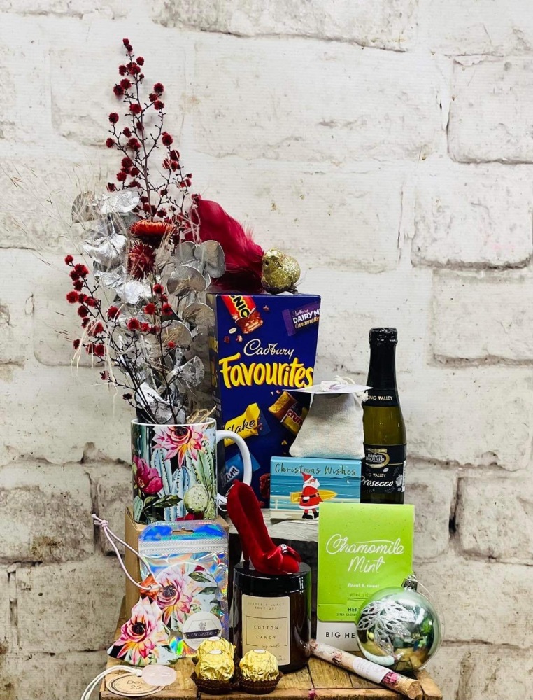 Hamper including  preserved flowers, chocolates, a small picolo bottle of sparkling wine, a soap in a decorative keepsake box, a locally made ceramic car coaster, ceramic ornament and mug, Big Heart herbal tea bags, Christmas decorations, bath salts, a satchel of lavender and a Little Village Boutique soy candle, delivered in Newcastle. 