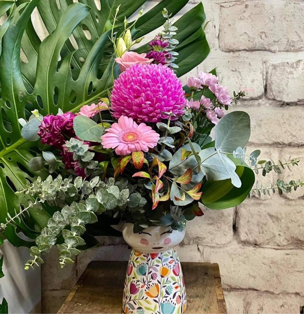 Fresh seasonal bouquet in lovely lady vase