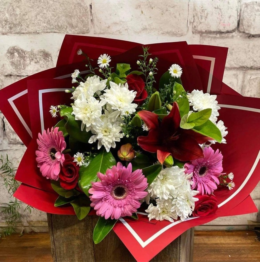 Mixed flower bouquet with roses in a vase